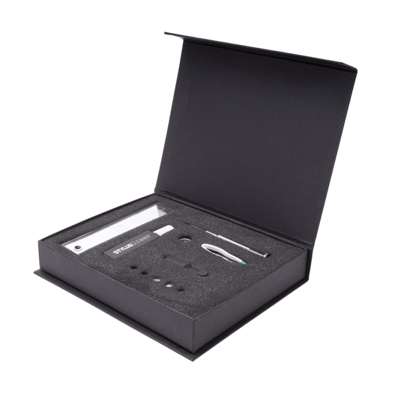 The Reloop turntable setup kit in its case, featuring an alignment protractor, stylus force gauge, and maintenance tools.